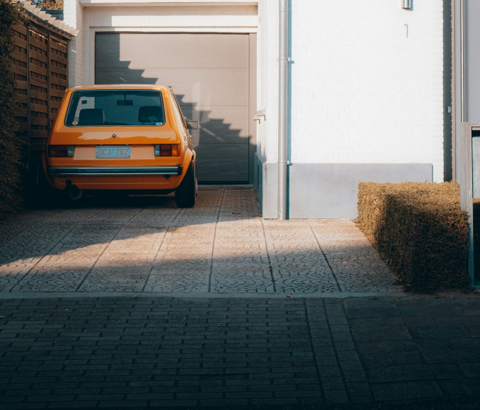 yellow car parked beside white building